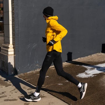 person running outdoors in athletic attire aside a city building person running outdoors in athletic attire aside a city building