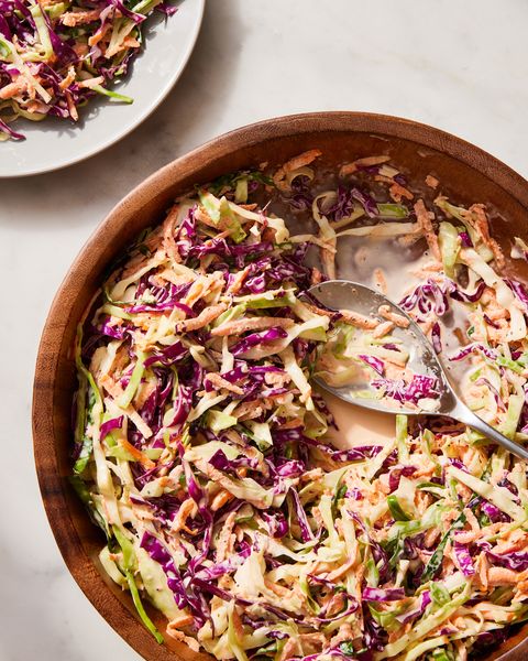 coleslaw made of shredded green cabbage, red cabbage, and carrots, in a creamy dressing