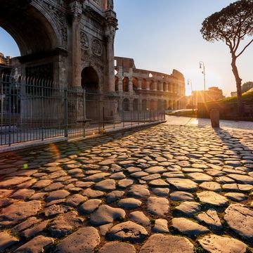 coliseum and arch of constantine at sunrise, rome, italy