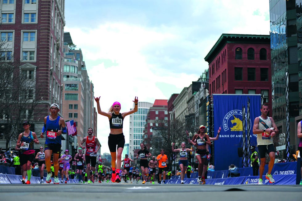 boston, massachusetts april 15: runners celebrates as they cross the finish line during the 128th boston marathon on april 15, 2024 in boston, massachusetts. (photo by paul rutherford/getty images)