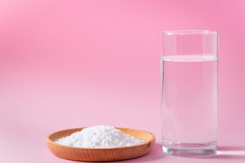 collagen powder in wooden bowl and glass of water on pink background biological natural protein supplement to food skin and bone health anti aging product
