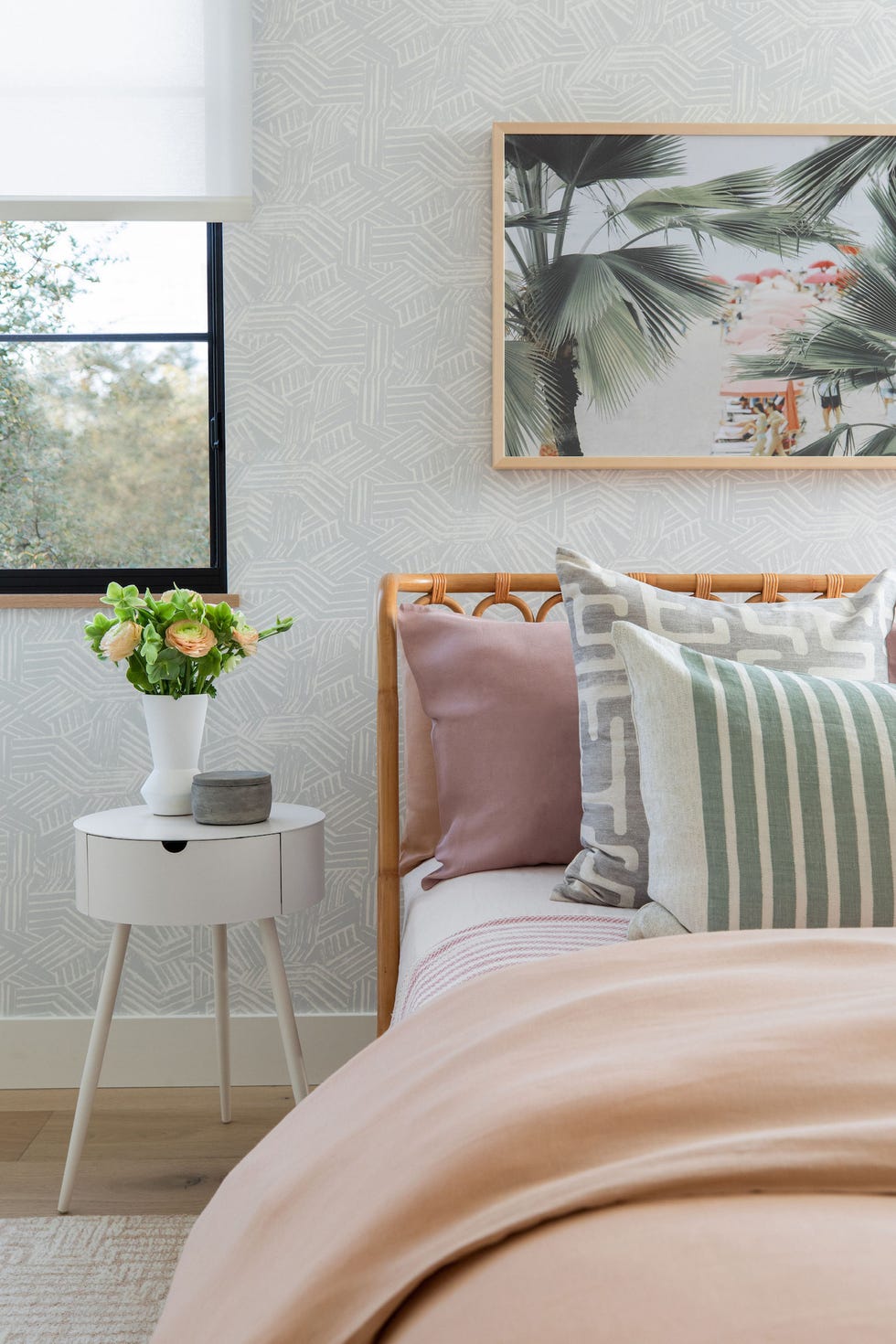 a couch with a table and a vase with flowers on it