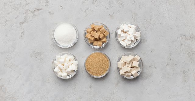 Collection of different kinds of sugar on gray background
