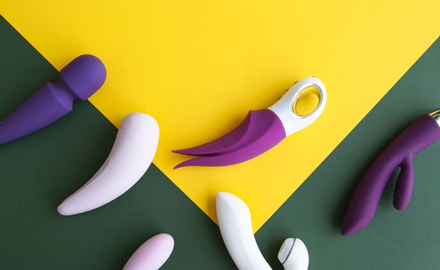 collection of different types of sex toys on a green and yellow background sex toys for adults, dildos, vibrators, clitoral stimulators