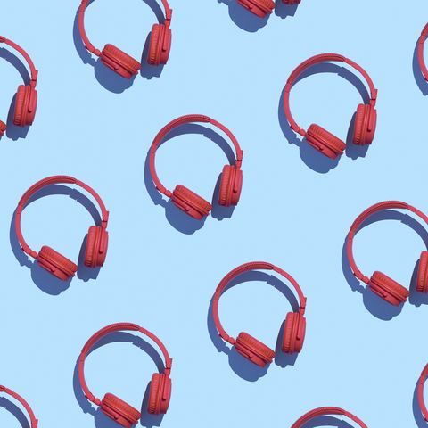 Collection of red wireless headphones on light blue background, 3D Rendering