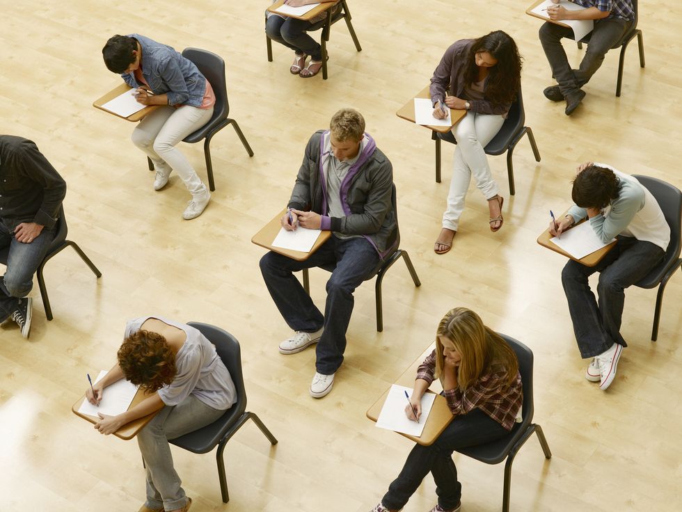 college students taking test in classroom