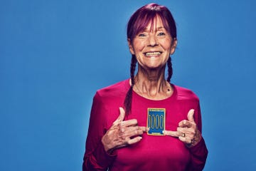 person wearing a red shirt proudly displaying a marathon achievement badge