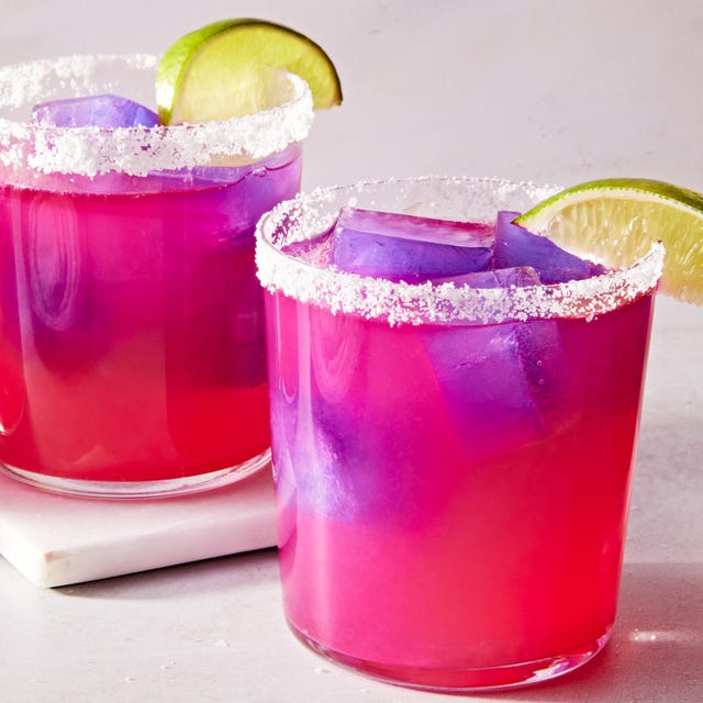 Color Changing Margaritas pink margarita with a purple ice cube with a salt rim and lime wedge