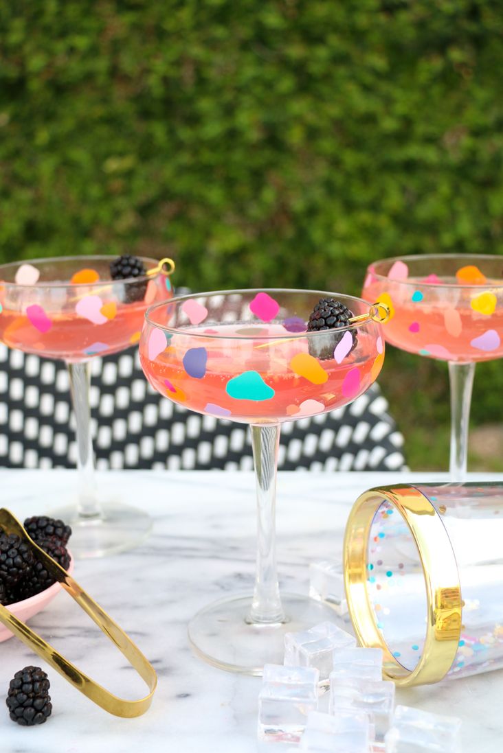 adult craft ideas, colorful coupe cocktail glasses on the table outdoors