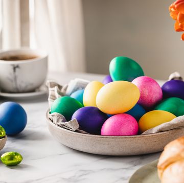 colorful easter eggs with cup of coffee on table
