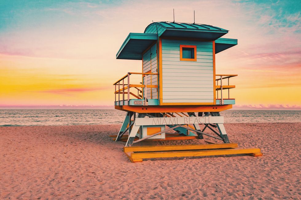 colorful miami beach lifeguard tower with stunning sunset sky and empty beach