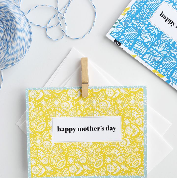 printable card with white on yellow botanical pattern with aqua border that says happy mother day in white rectangle