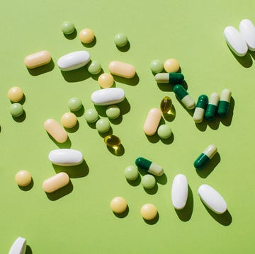 Colorful pills and capsules on green background. Minimal medical concept. Flat lay, top view. colorful pills and capsules on green background minimal medical concept flat lay, top view