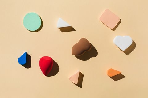 Colorful sponges for make-up on a beige background