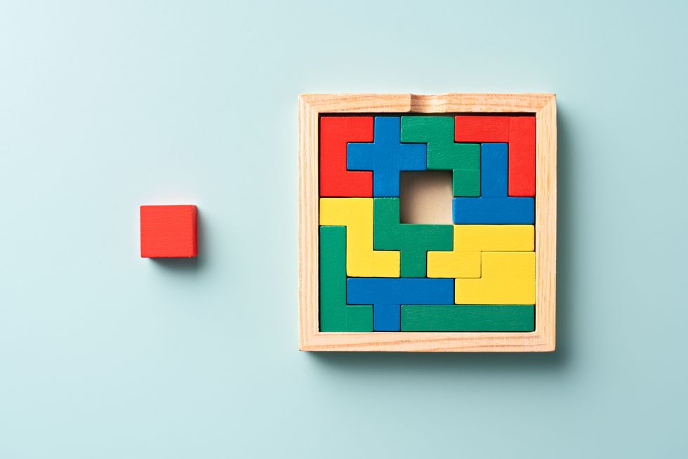 colorful wooden puzzle with a final piece