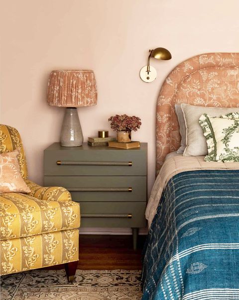 bedroom with  pink walls and eclectic bedding