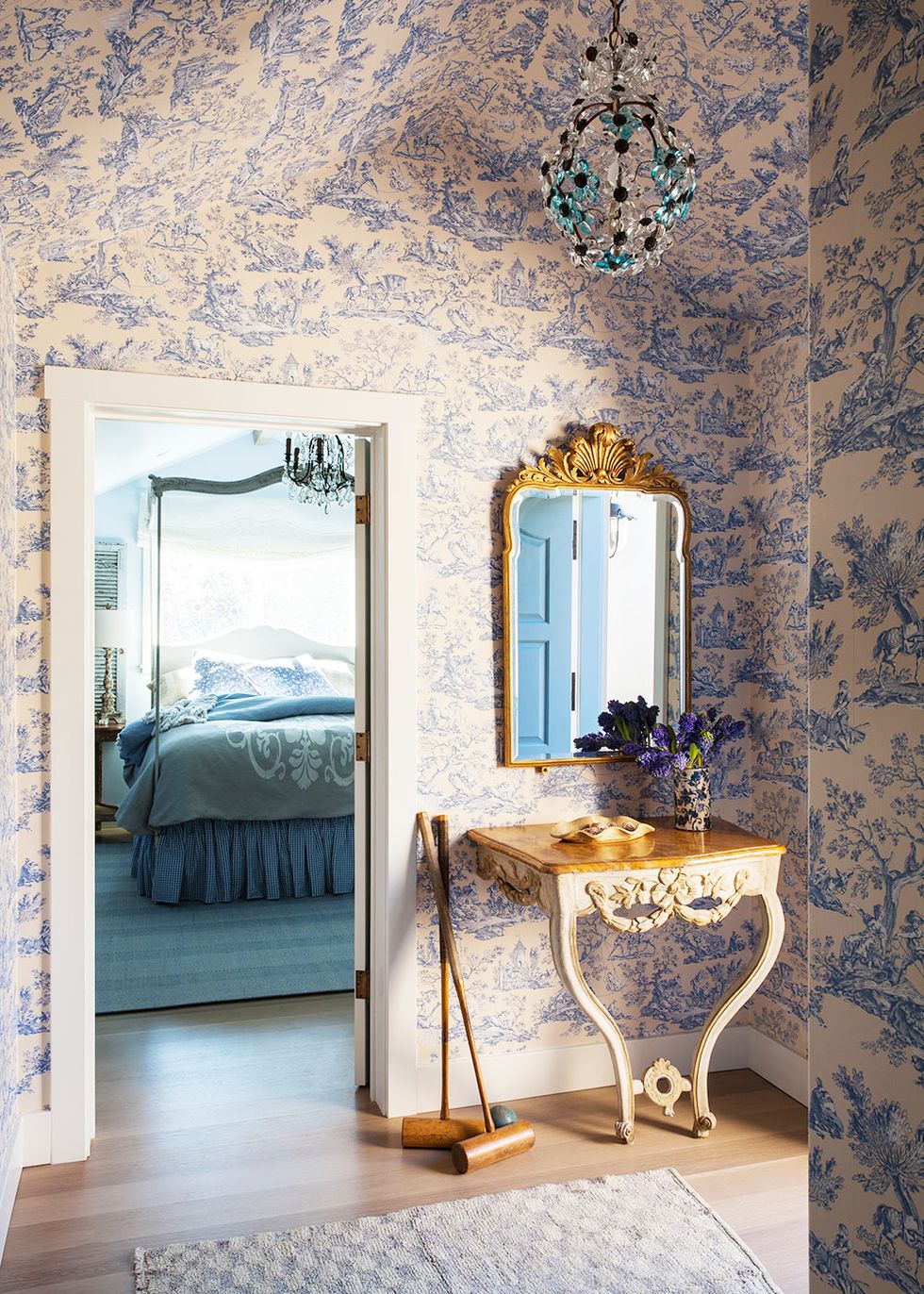 vestibule with toile wallpaper and floral crystal pendant