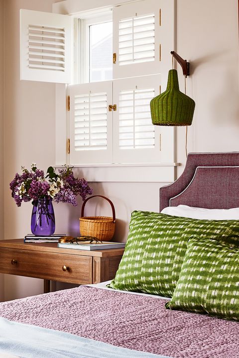 bedroom with purple and green bedding