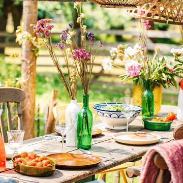 colourful decorated table in summer setting. garden party. lunch. summer garden patio terrace.