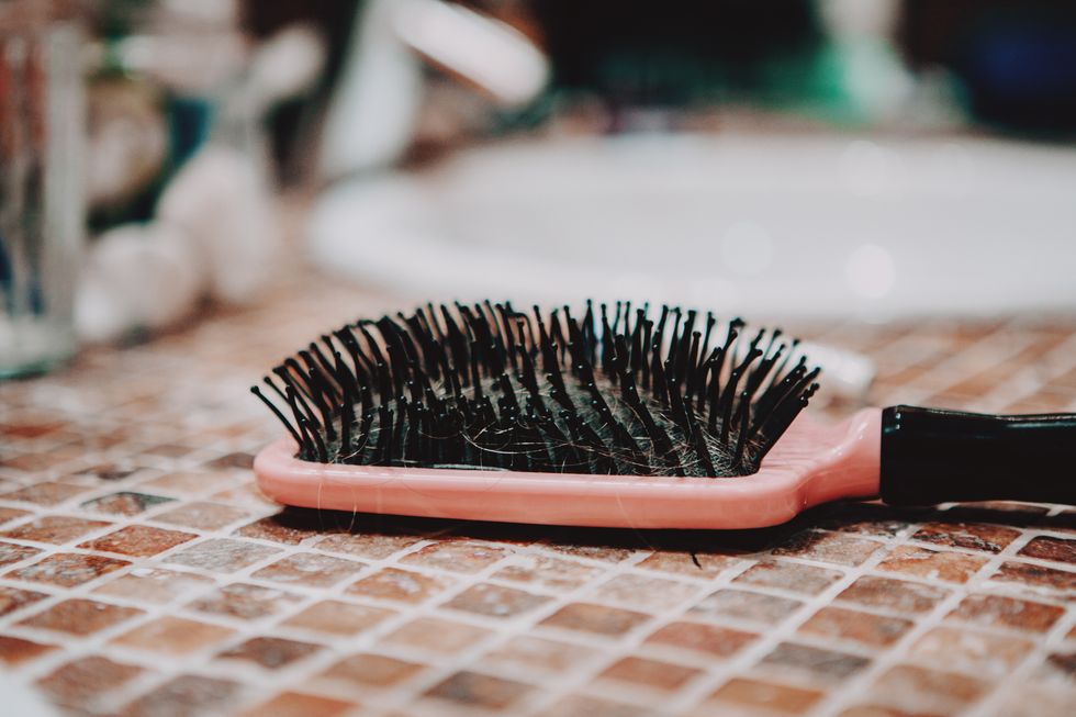 comb hair with tufts in bathroom
