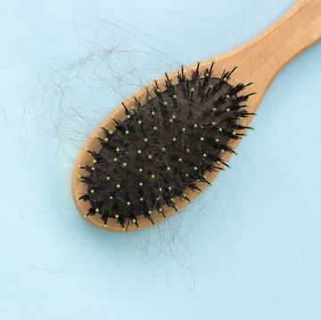 comb with hair on a blue background, the problem of hair loss, the concept of hair care