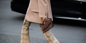 paris, france   march 02 clara berry is seen wearing beige brown checkered flared pants, brown acne bag, beige blazer, grey top, heels outside acne during paris fashion week   womenswear fw 2022 2023 on march 02, 2022 in paris, france photo by christian vieriggetty images