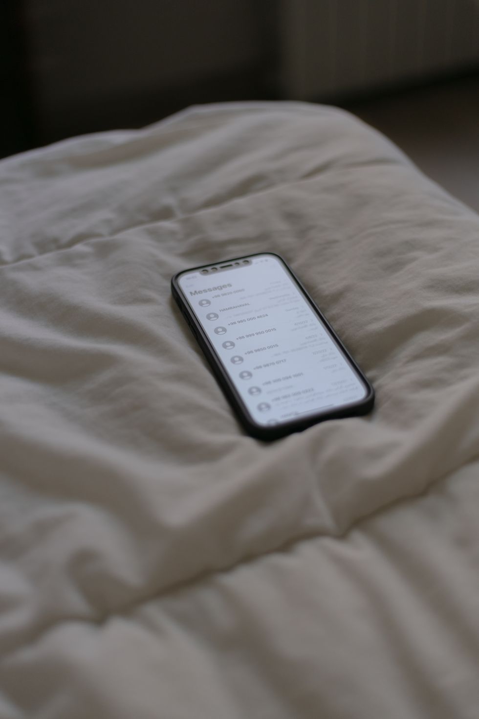 a cell phone on a bed