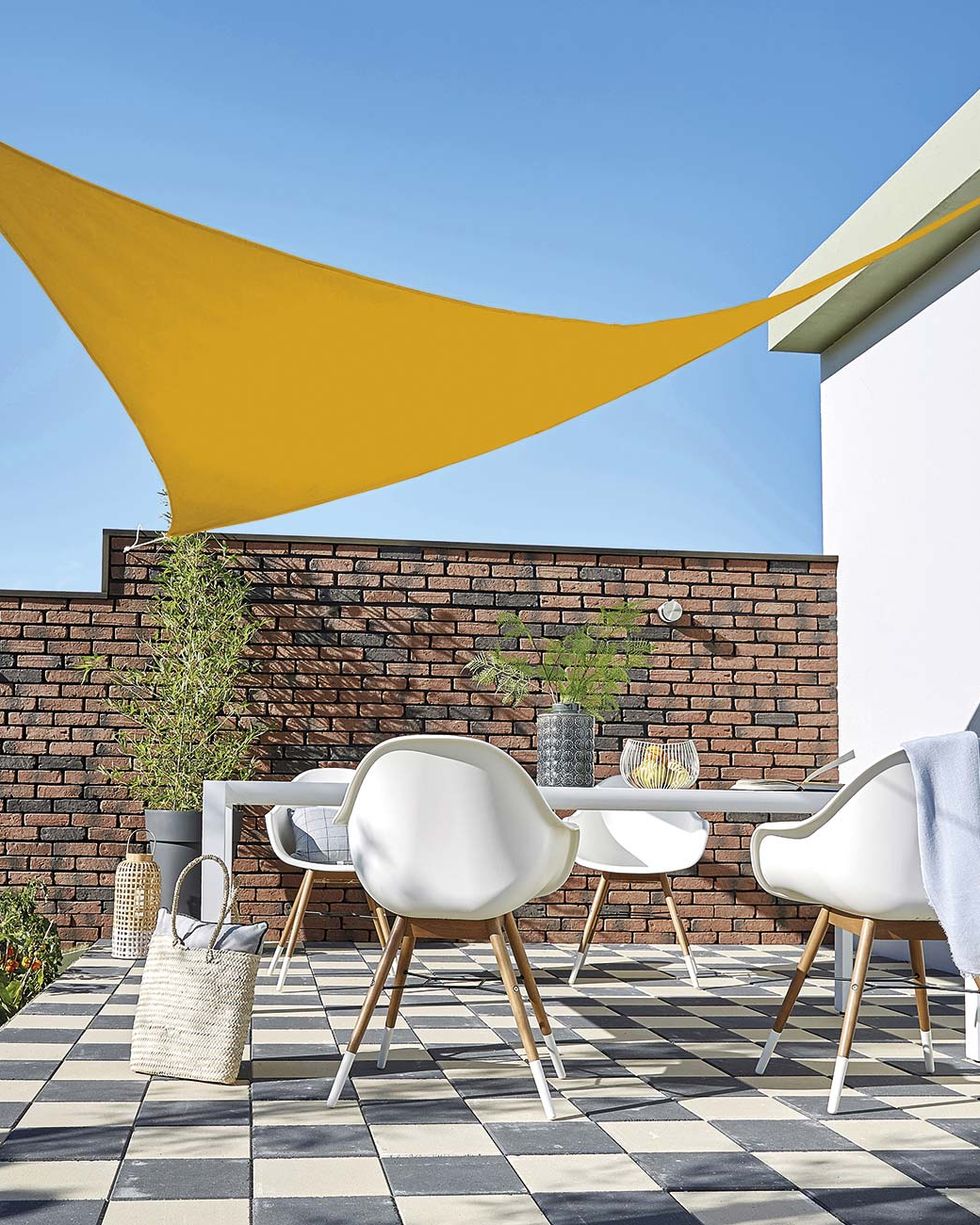 modern outdoor dining room with sail awning