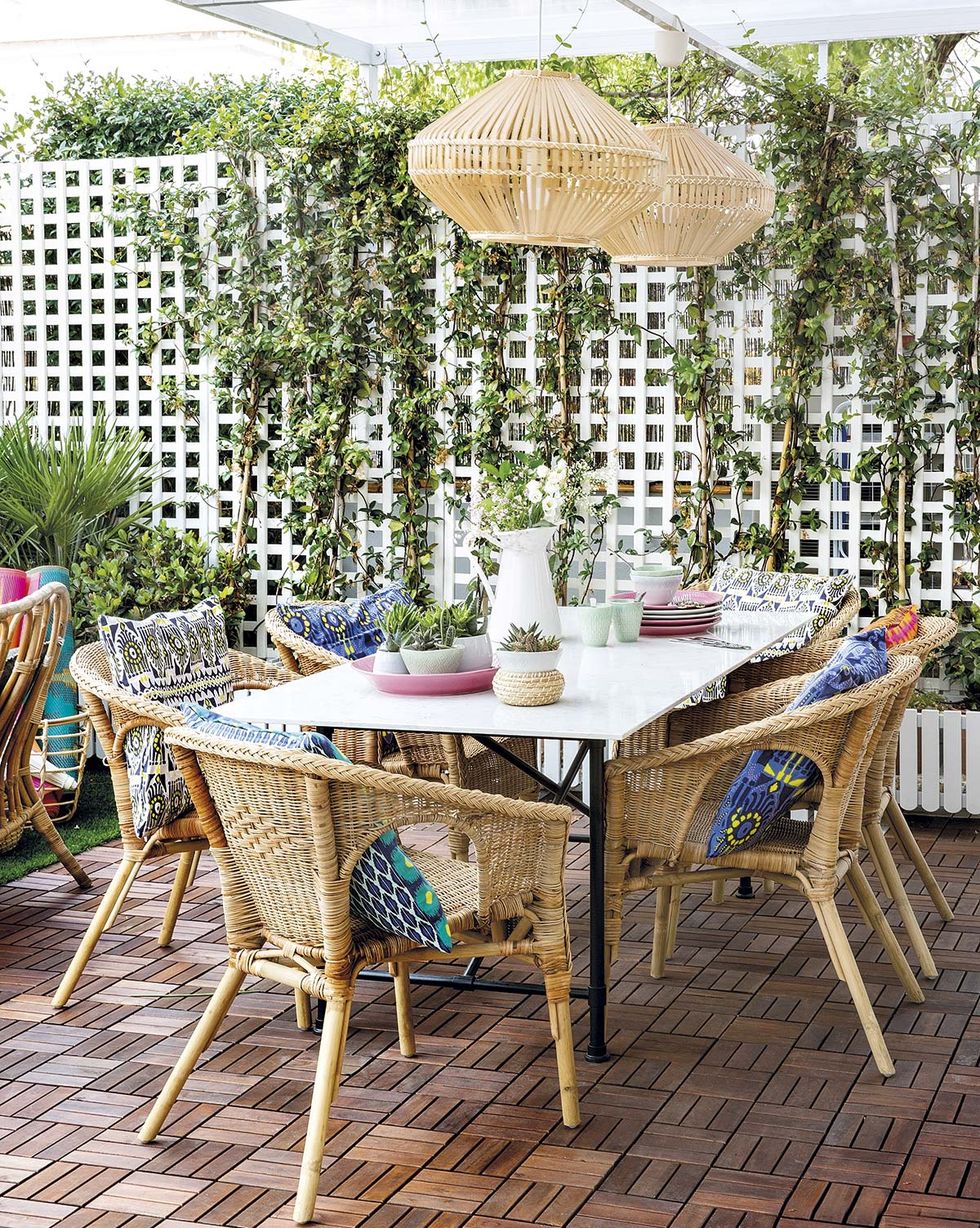 outdoor dining room with white table and fiber chairs