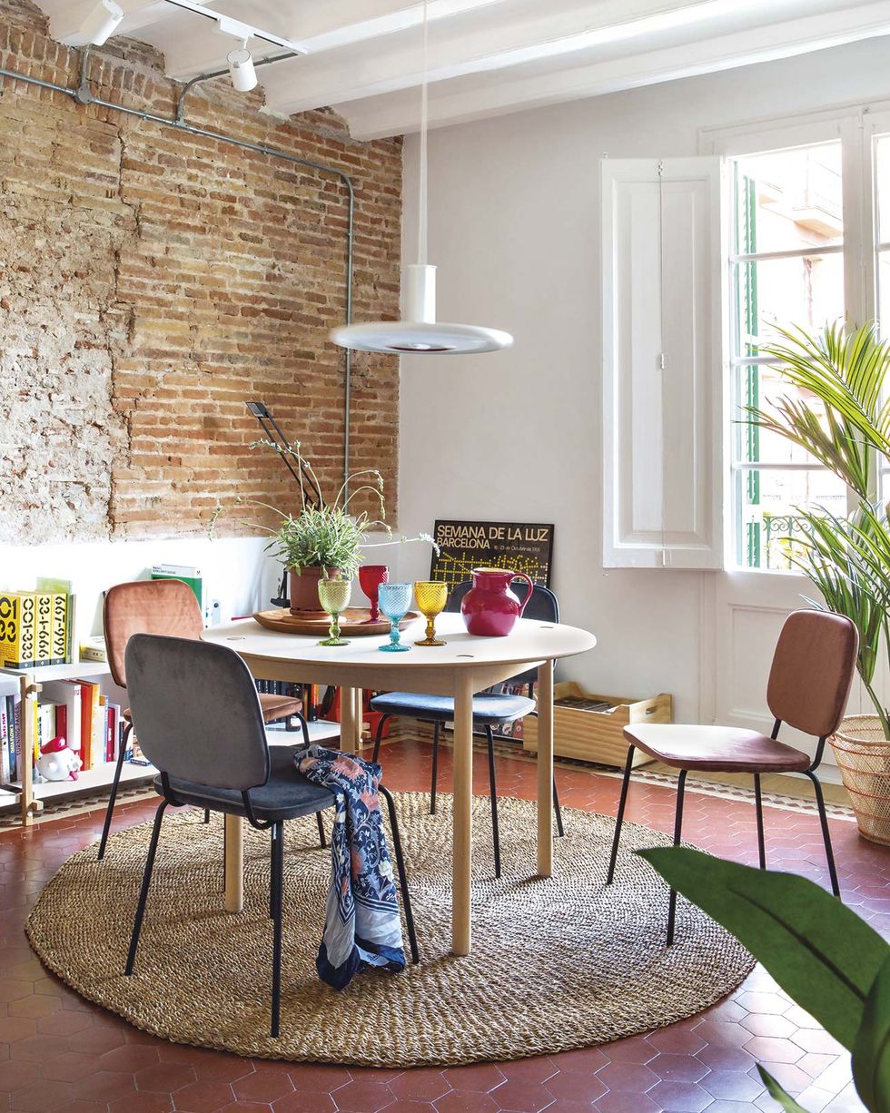 dining room with brick wall and round table
