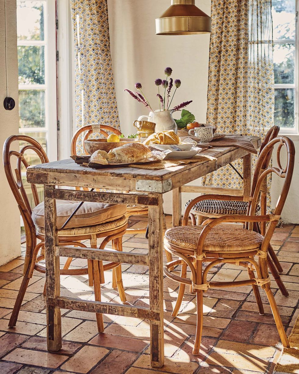rustic dining room with wooden and cane table and chairs