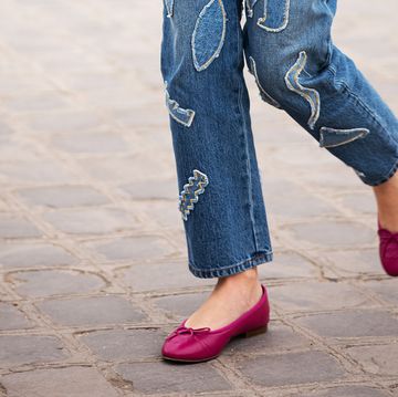 a pair of legs wearing jeans and pink shoes