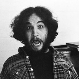 a man looks at the camera with a wide open mouth and a look of fake shock
