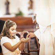 communion scripture girl taking her first communion at church