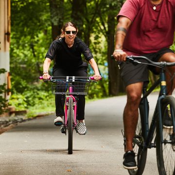 two cyclists on commuter bikes on a bike path