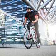 Commuter cycling fast at work in the morning Commuter cycling fast at work in the morning