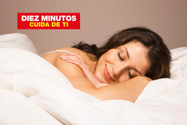 hispanic woman laying in bed smiling in sleep