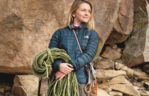 woman holding rock climbing gear