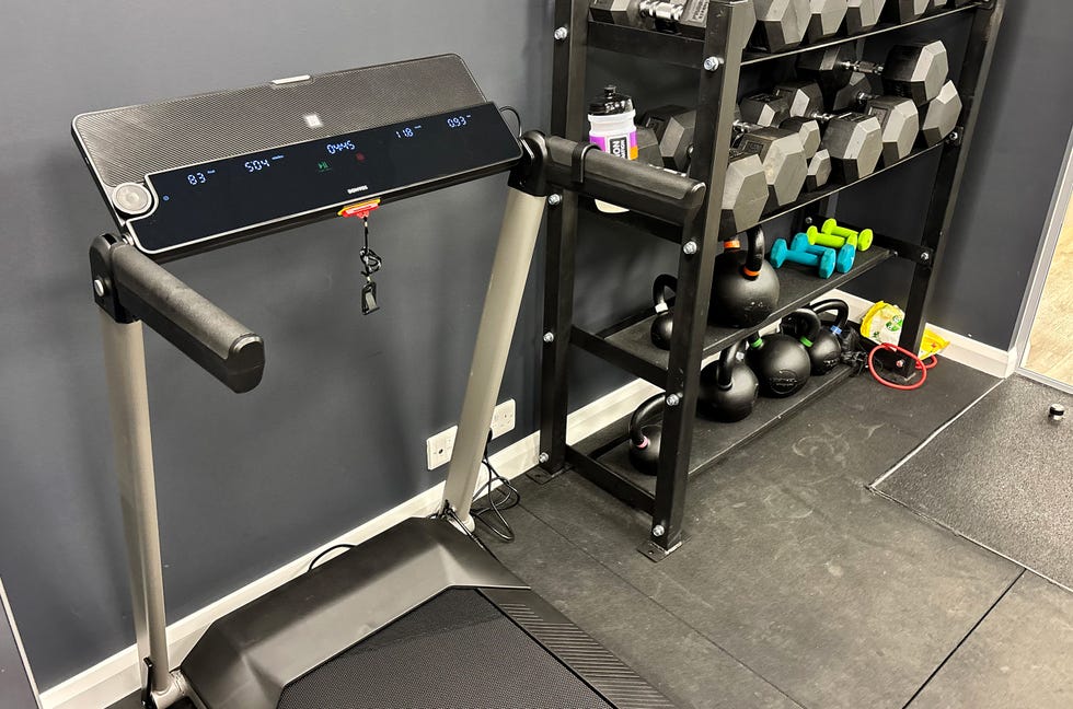 wide shot of a treadmill besides some weights