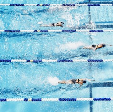 Competitive swimmers racing in outdoor pool