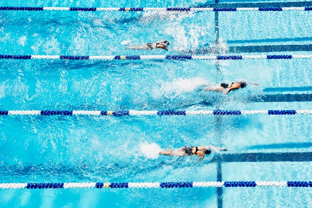 Competitive swimmers racing in outdoor pool