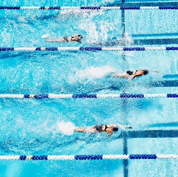 Competitive swimmers racing in outdoor pool