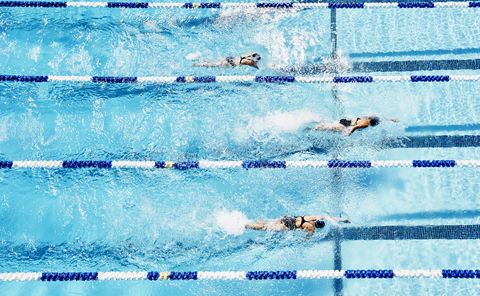 competitive swimmers racing in outdoor pool
