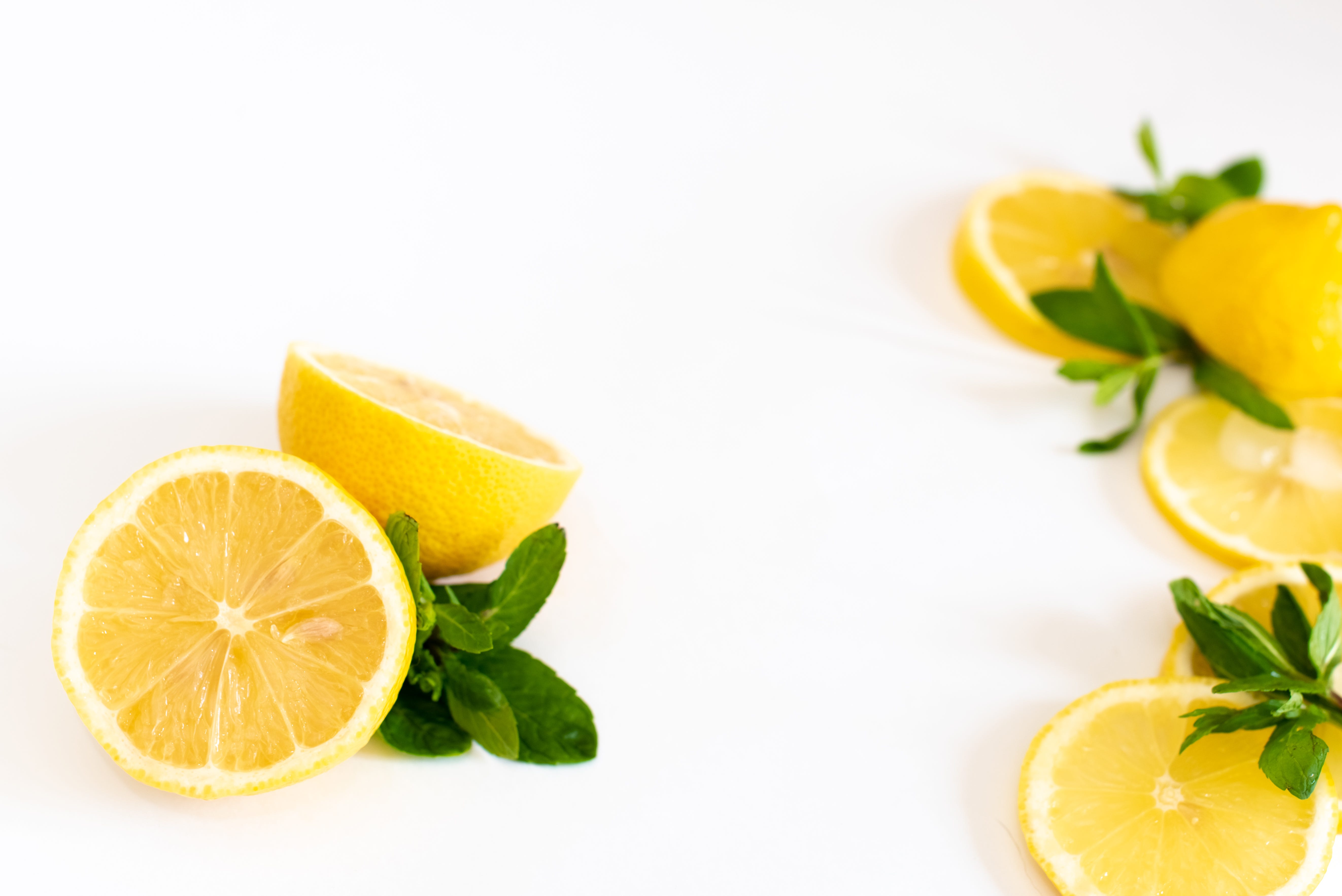 Composition of delicious citrus fruit and green leaves on white background