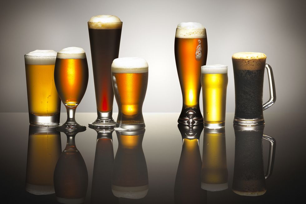 a composition of frothy beers in beer glasses