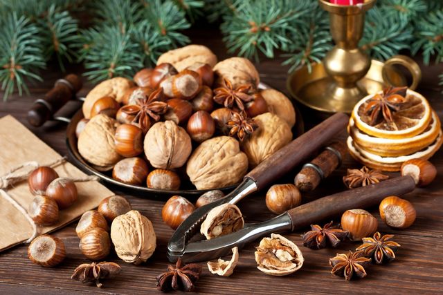 composition with nuts and nutcracker on wooden background christmas concept