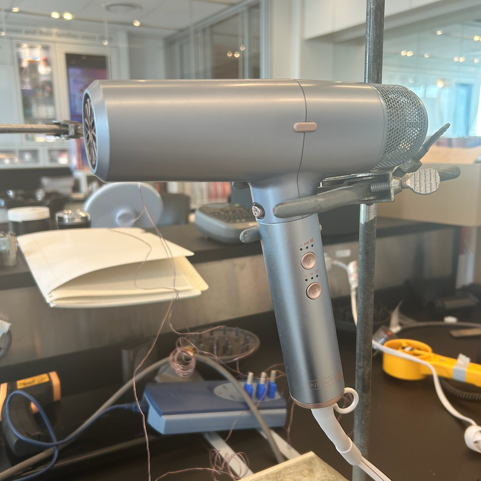 a testing photo of a conair hair dryer, one of good housekeeping's picks for best travel hair dryers