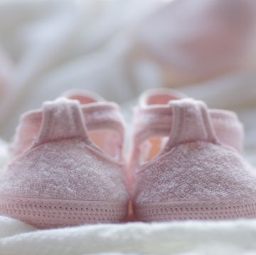 small pink shoes on a white blanket