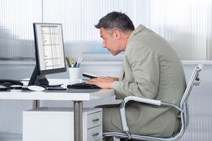 concentrated businessman using computer at desk