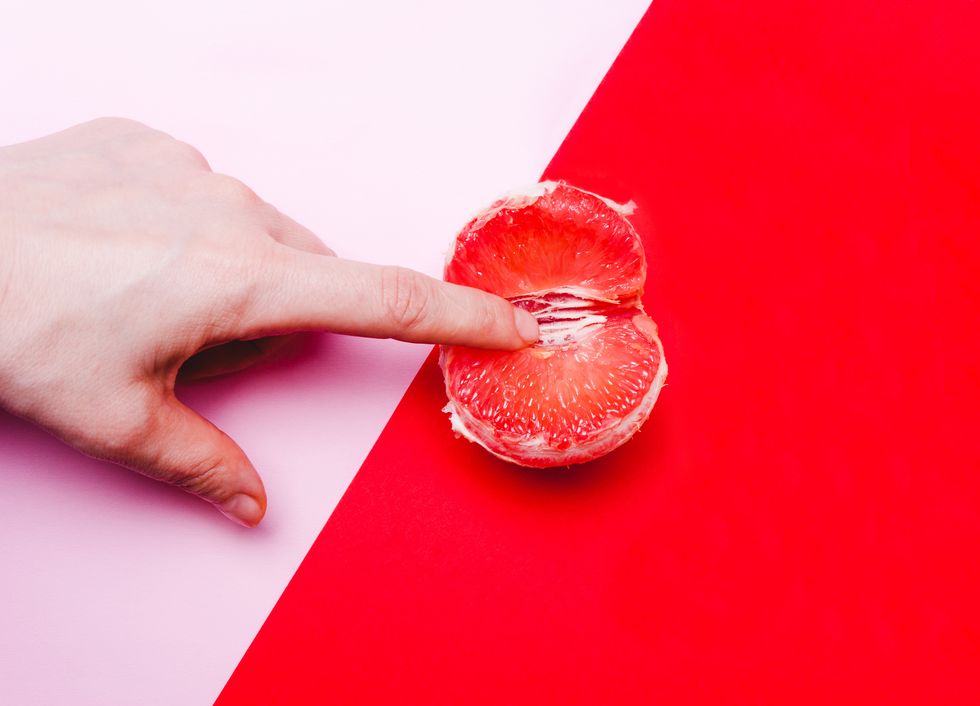 concept sex, masturbation hand, fingers in grapefruit, vagina symbol